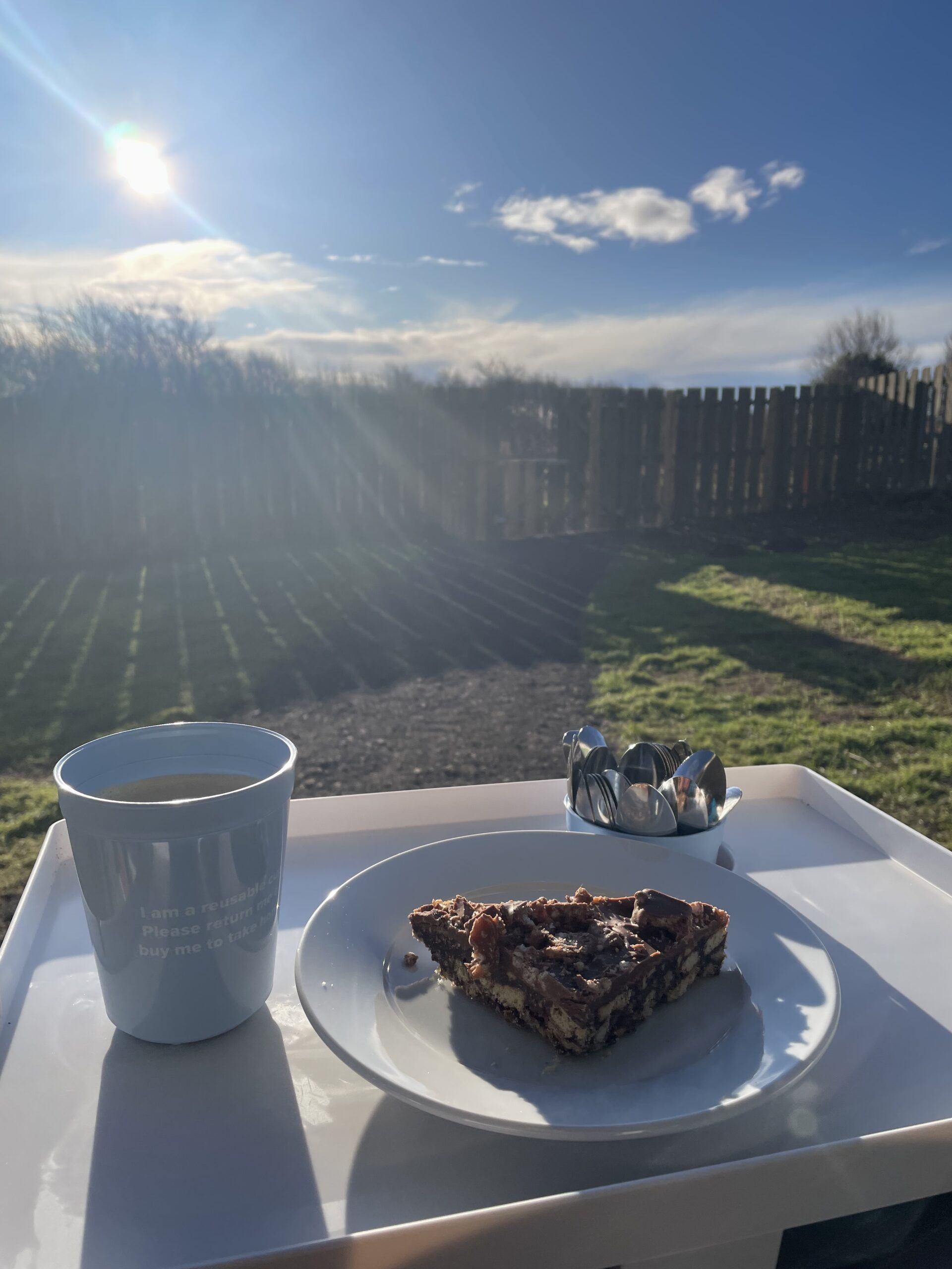 Cake and coffee outside in the sun