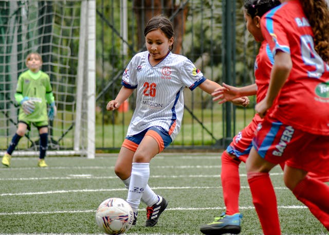 Girls playing football.