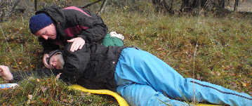 Two people practicing First Aid