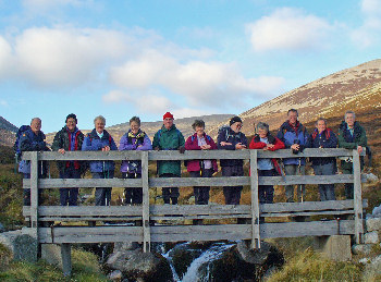 Group photo of hikers on a bridge